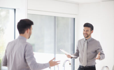 Mid,Adult,Businessman,Practicing,Presentation,In,Mirror